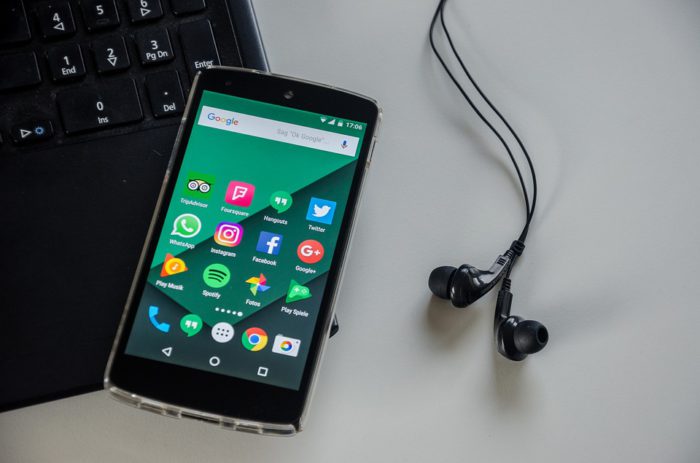 Smartphone mit Ohrstöpseln liegt auf einem Laptop. Ob hier Musik am Arbeitsplatz gehört wird? Bild: Pixabay