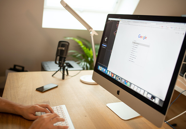 DuckDuckGo-Browser: iMac auf Schreibtisch, Hände auf Tastatur. Bild: Pexels/Philipp Pistis